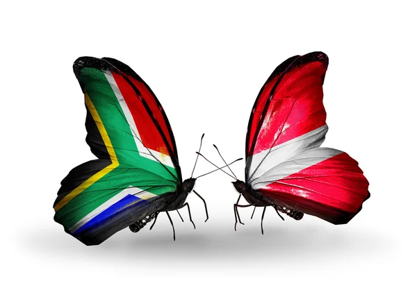 Two butterflies with flags on wings as symbol of relations South Africa and Latvia — Stock Photo, Image