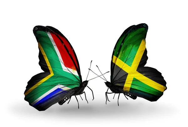 Dos mariposas con banderas en alas como símbolo de las relaciones Sudáfrica y Jamaica —  Fotos de Stock