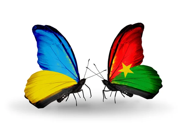 Twee vlinders met vlaggen op vleugels als symbool van betrekkingen Oekraïne en burkina faso — Stockfoto