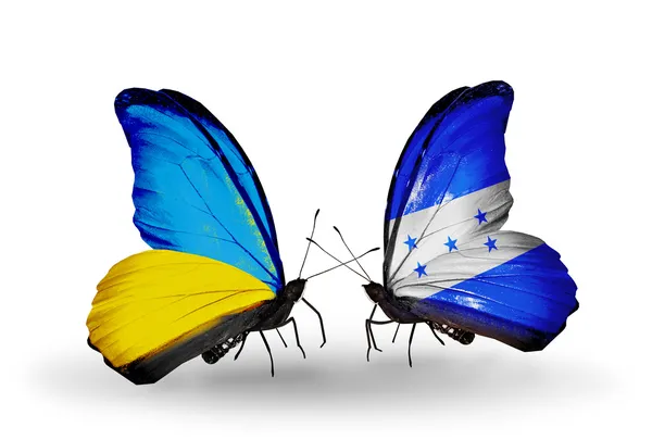 Due farfalle con bandiere sulle ali come simbolo delle relazioni Ucraina e Honduras — Foto Stock