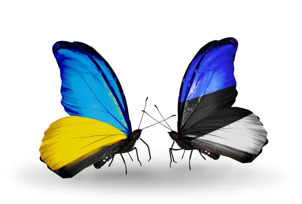 Dva motýli s příznaky na křídlech jako symbol vztahů, Ukrajina a Estonsko — Stock fotografie