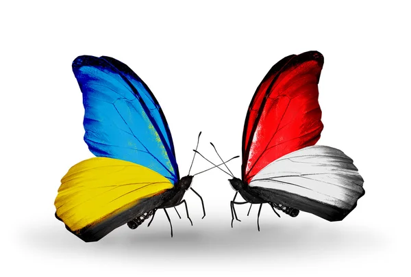 Two butterflies with flags on wings as symbol of relations Ukraine and Monaco, Indonesia — ストック写真