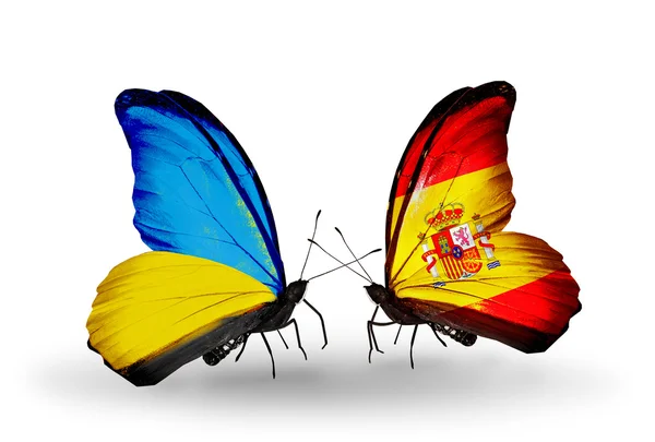 Deux papillons avec des drapeaux sur les ailes comme symbole des relations Ukraine et Espagne — Photo