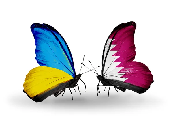 Two butterflies with flags on wings as symbol of relations Ukraine and Qatar — Stock Photo, Image