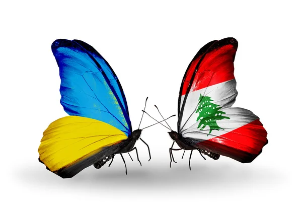 Deux papillons avec des drapeaux sur les ailes comme symbole des relations Ukraine et Liban — Photo