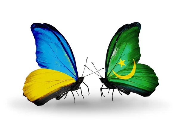 Due farfalle con bandiere sulle ali come simbolo delle relazioni Ucraina e Mauritania — Foto Stock