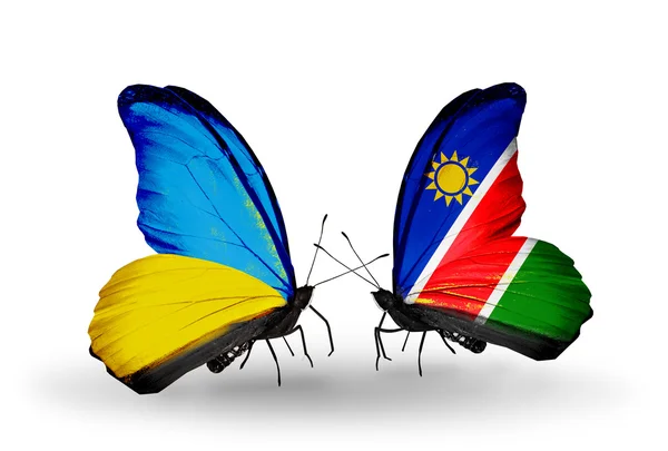Due farfalle con bandiere sulle ali come simbolo delle relazioni Ucraina e Namibia — Foto Stock