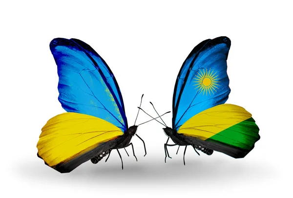 Deux papillons avec des drapeaux sur les ailes comme symbole des relations Ukraine et Rwanda — Photo