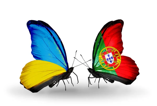 Two butterflies with flags on wings as symbol of relations Ukraine and Portugal — Zdjęcie stockowe