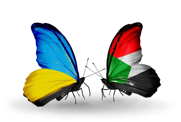 Dva motýli s příznaky na křídlech jako symbol vztahů, Ukrajina a Súdán — Stock fotografie