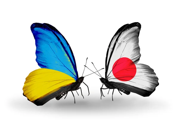 Две бабочки с флагами на крыльях как символ отношений Украины и Японии — стоковое фото