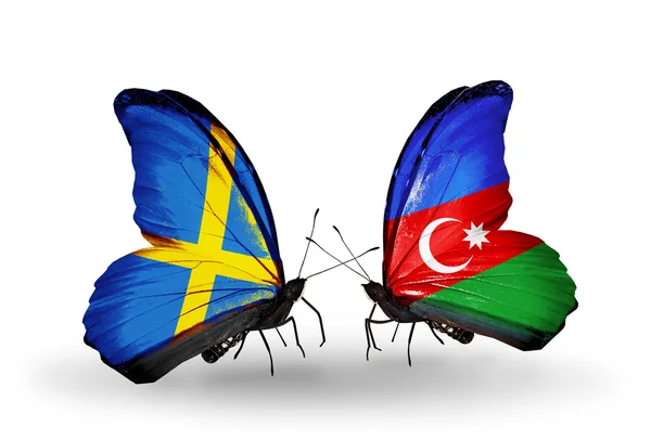 Twee vlinders met vlaggen op vleugels als symbool van betrekkingen Zweden en Azerbeidzjan — Stockfoto