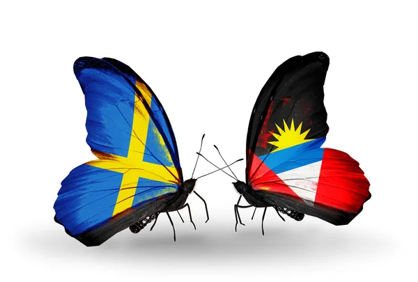 Two butterflies with flags on wings as symbol of relations Sweden and Antigua and Barbuda — Stock Photo, Image