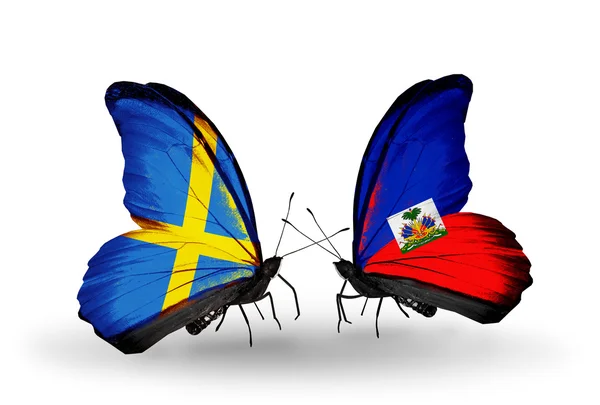 Two butterflies with flags on wings as symbol of relations Sweden and Haiti — Stock Photo, Image