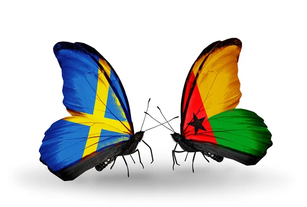Two butterflies with flags on wings as symbol of relations Sweden and Germany — Stock Photo, Image