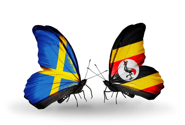 Two butterflies with flags on wings as symbol of relations Sweden and Uganda — Stock Photo, Image