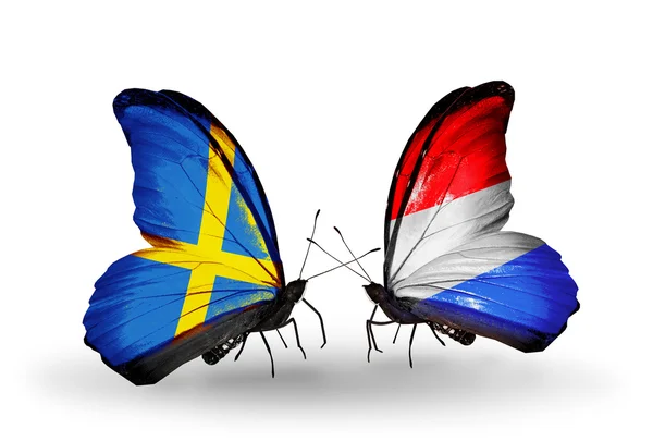 Two butterflies with flags on wings as symbol of relations Sweden and Luxembourg — Stock Photo, Image