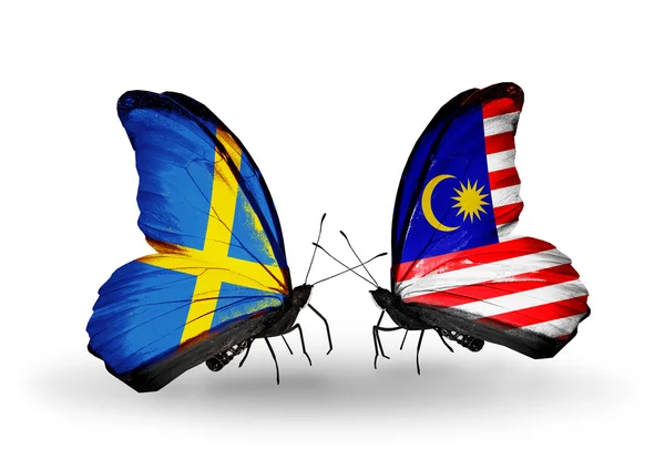 Two butterflies with flags on wings as symbol of relations Sweden and Malaysia — Stock Photo, Image