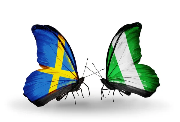 Two butterflies with flags on wings as symbol of relations Sweden and Nigeria — Stock Photo, Image