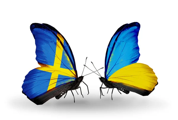 Two butterflies with flags on wings as symbol of relations Sweden and Ukraine — Stock Photo, Image