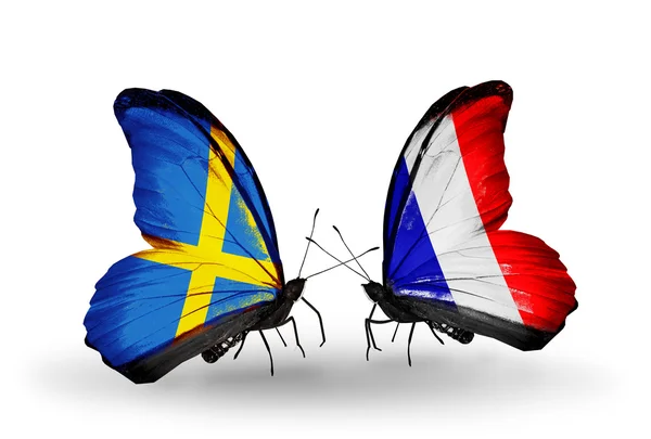 Two butterflies with flags on wings as symbol of relations Sweden and France — Stock Photo, Image