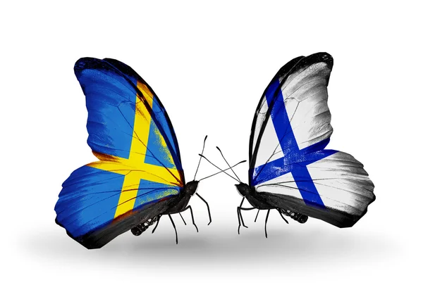 Two butterflies with flags on wings as symbol of relations Sweden and Finland — Stock Photo, Image