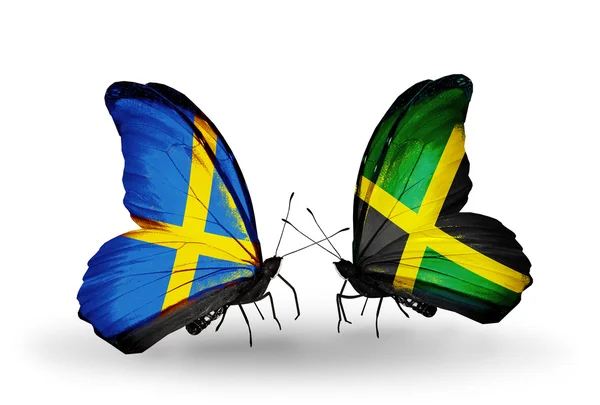 Twee vlinders met vlaggen op vleugels als symbool van betrekkingen Zweden en jamaica — Stockfoto