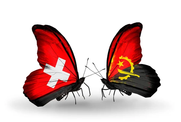 Duas borboletas com bandeiras da Suíça e Angola em asas — Fotografia de Stock