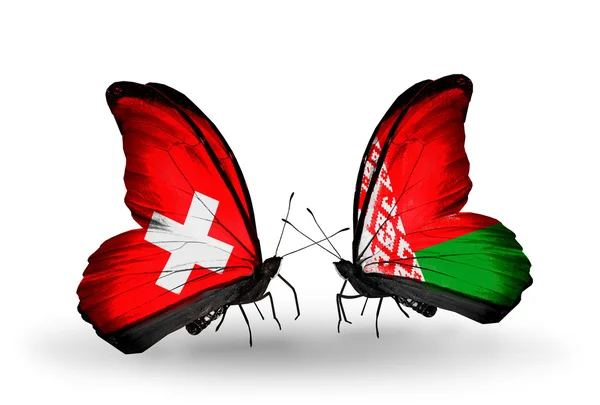 Dwa motyle z flagami Szwajcaria i Białorusi na skrzydłach — Zdjęcie stockowe
