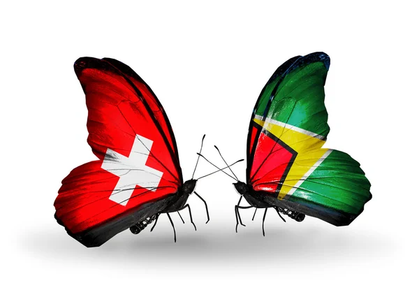 Two butterflies with flags of Switzerland and Guyana on wings — Stock Photo, Image