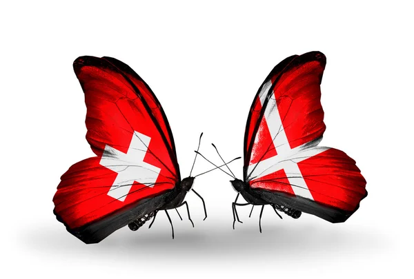 Two butterflies with flags of Switzerland and Denmark on wings — Stock Photo, Image