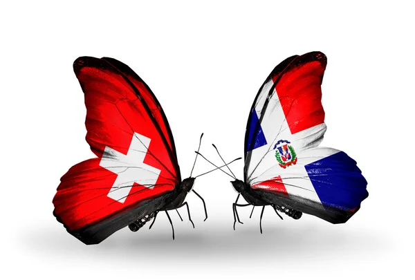 Deux papillons avec des drapeaux de Suisse et Dominicana sur les ailes — Photo