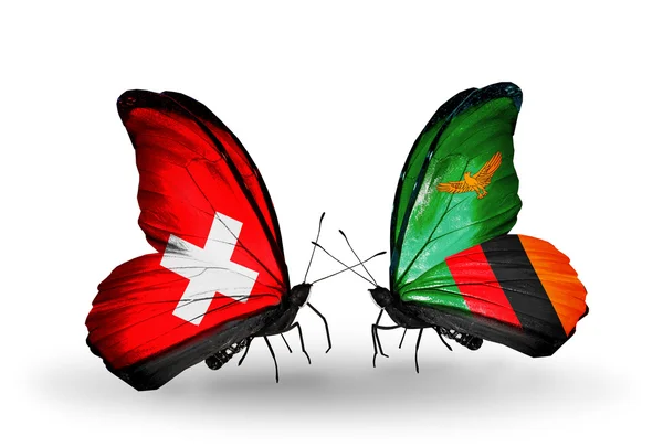 Dwa motyle z flagami Szwajcaria i Zambii na skrzydłach — Zdjęcie stockowe