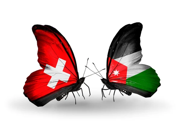 Two butterflies with flags of Switzerland and Jordan on wings — Stock Photo, Image