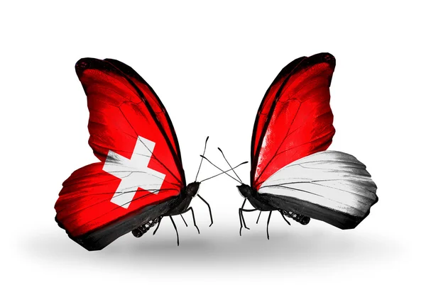 Dos mariposas con banderas de Suiza y Mónaco, Indonesia en alas — Foto de Stock