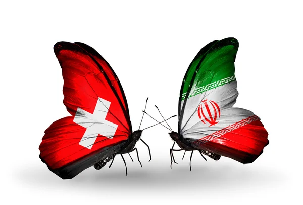 Zwei Schmetterlinge mit schweizer und iranischer Flagge auf Flügeln — Stockfoto