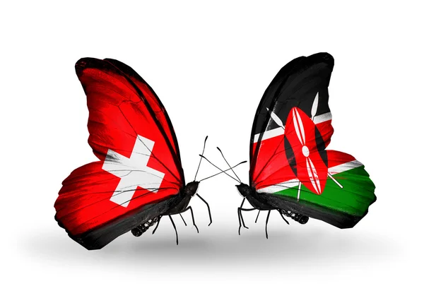 Two butterflies with flags of Switzerland and Kenya on wings — Stock Photo, Image