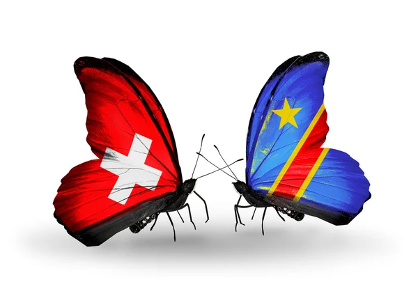 Zwei Schmetterlinge mit Flaggen der Schweiz und des Kongo auf Flügeln — Stockfoto