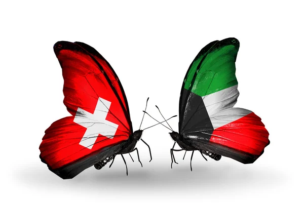 Two butterflies with flags of Switzerland and Kuwait on wings — Stock Photo, Image