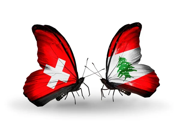 Two butterflies with flags of Switzerland and Lebanon on wings — Stock Photo, Image