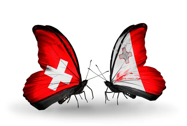 Dos mariposas con banderas de Suiza y Malta en alas — Foto de Stock