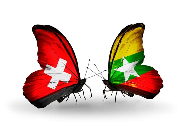 Duas borboletas com bandeiras da Suíça e Mianmar em asas — Fotografia de Stock