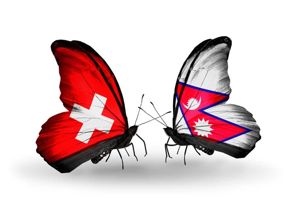 Due farfalle con le bandiere di Svizzera e Nepal sulle ali — Foto Stock