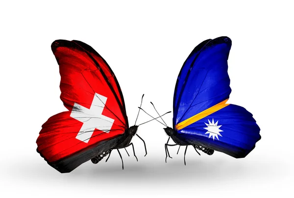 Two butterflies with flags of Switzerland and Nauru on wings — Stock Photo, Image