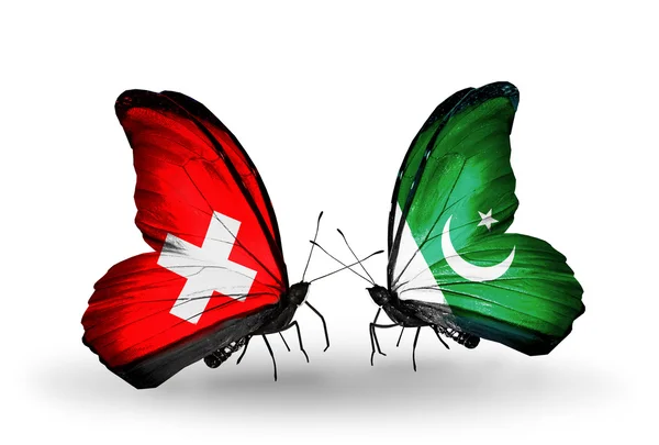 Two butterflies with flags of Switzerland and Pakistan on wings — Stock Photo, Image