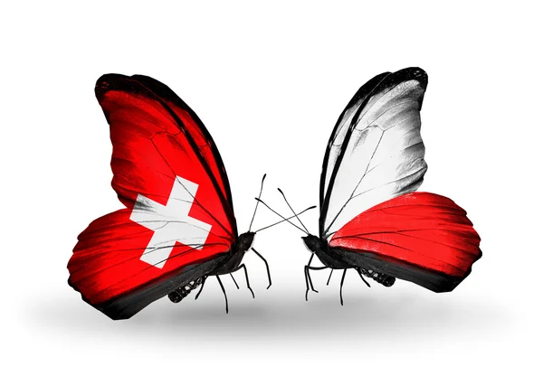 Iki kelebek kanatları üzerinde İsviçre ve Polonya bayrağı ile — Stok fotoğraf