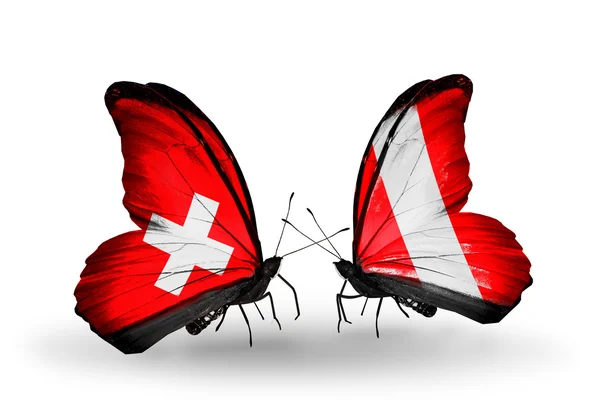 Dva motýli s vlajkami Švýcarska a peru na křídlech — Stock fotografie