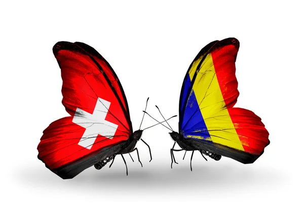 Duas borboletas com bandeiras da Suíça e Chade, Romênia em asas — Fotografia de Stock