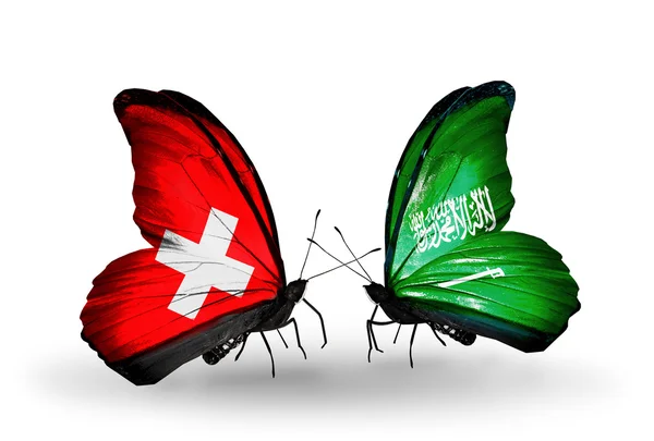 Deux papillons avec des drapeaux de Suisse et d'Arabie Saoudite sur les ailes — Photo