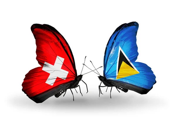 Two butterflies with flags on wings as symbol of relations Switzerland and Saint Lucia — Stock Photo, Image